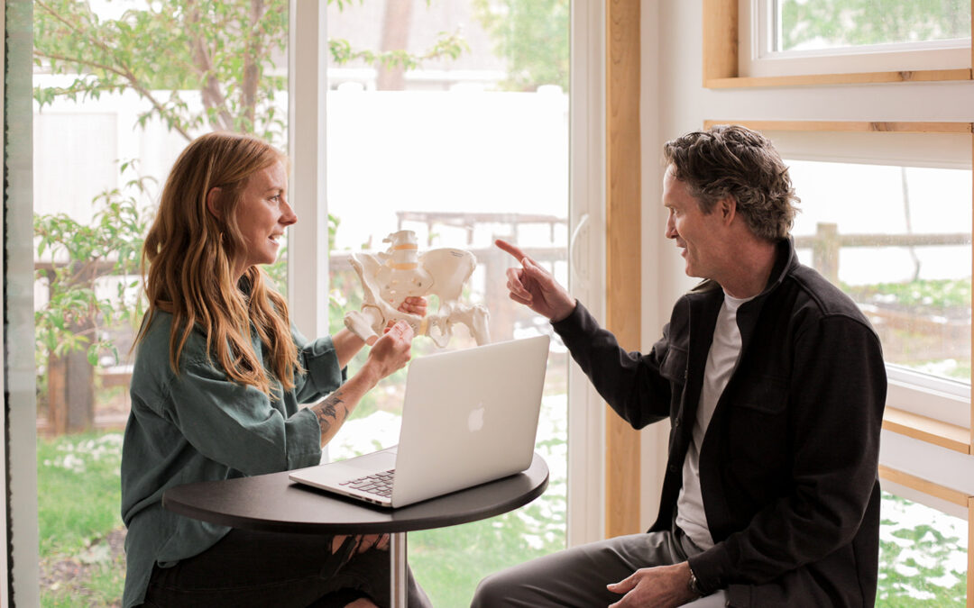 Dr. Emily Warren consulting with patient about bone health exercise program using anatomical model